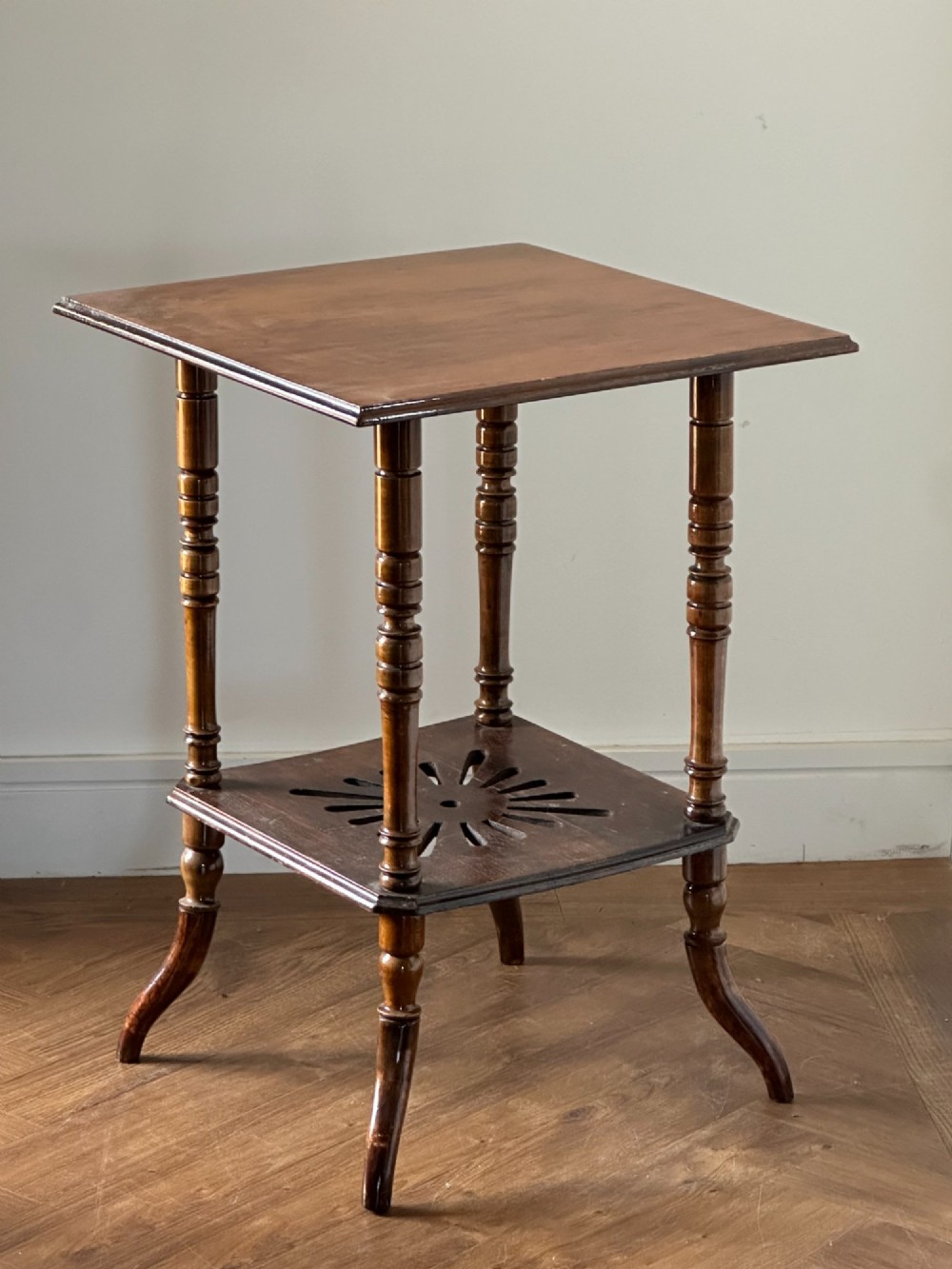 An Anglo-Japanese two-tier wooden occasional table featuring turned spindle legs, a square top, and a pierced lower shelf. View VII