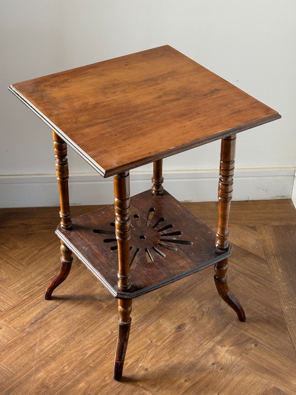 An Anglo-Japanese two-tier wooden occasional table featuring turned spindle legs, a square top, and a pierced lower shelf. View VIII