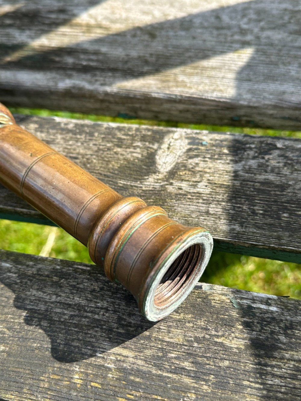 A circular Georgian copper moon flask with a threaded top loop, displayed alongside a separate turned dark oak handle. View VI
