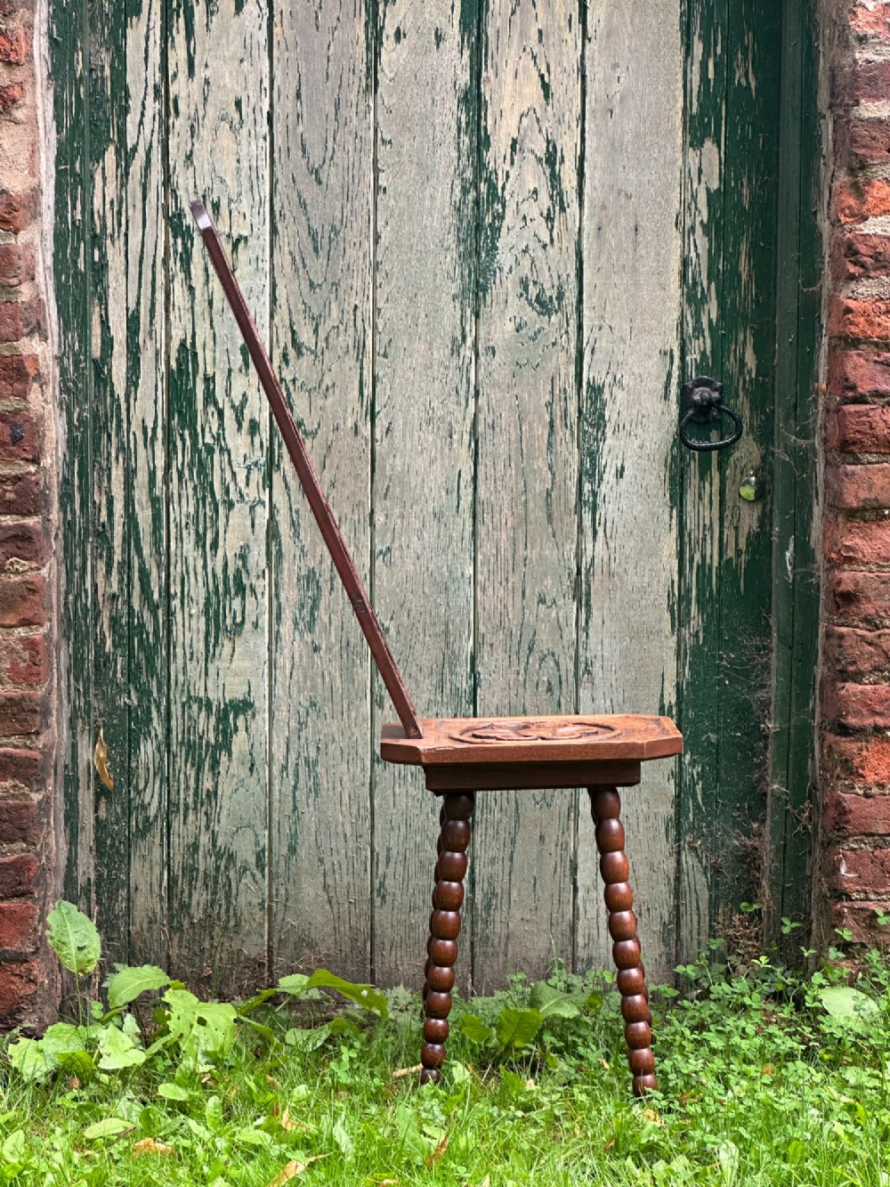 A wonderfully eccentric Arts and Crafts carved elm and oak spinning stool c.1900