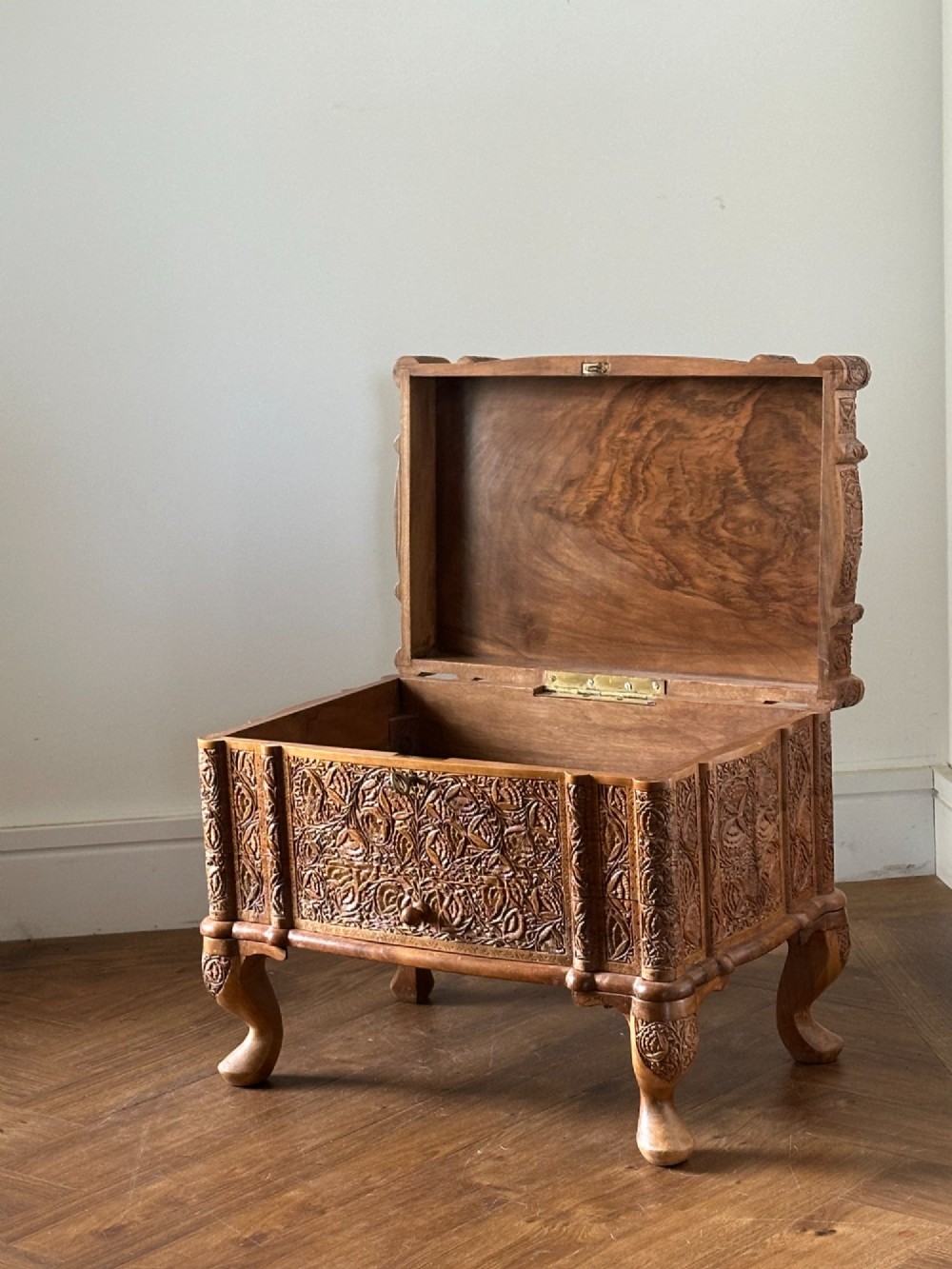 An intricately carved Anglo-Indian wooden jewellery casket featuring a sarcophagus-shaped lid and raised cabriole legs. View VIII