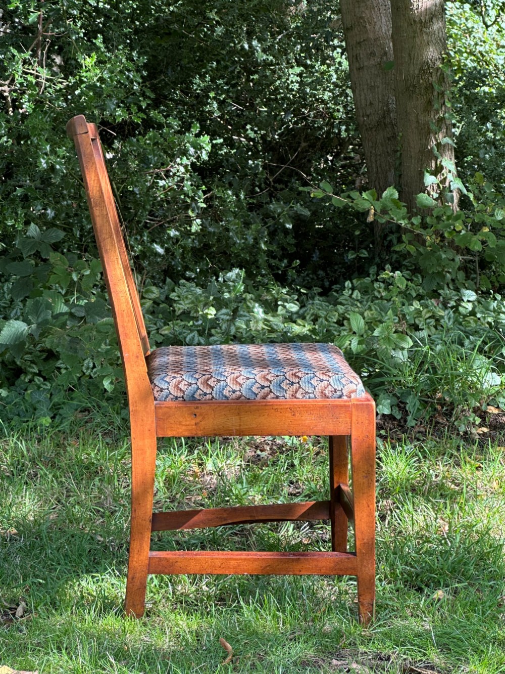 A George III solid birch side chair featuring a vertical reeded slat back, patterned geometric fabric seat, and square tapered legs with stretchers. View V