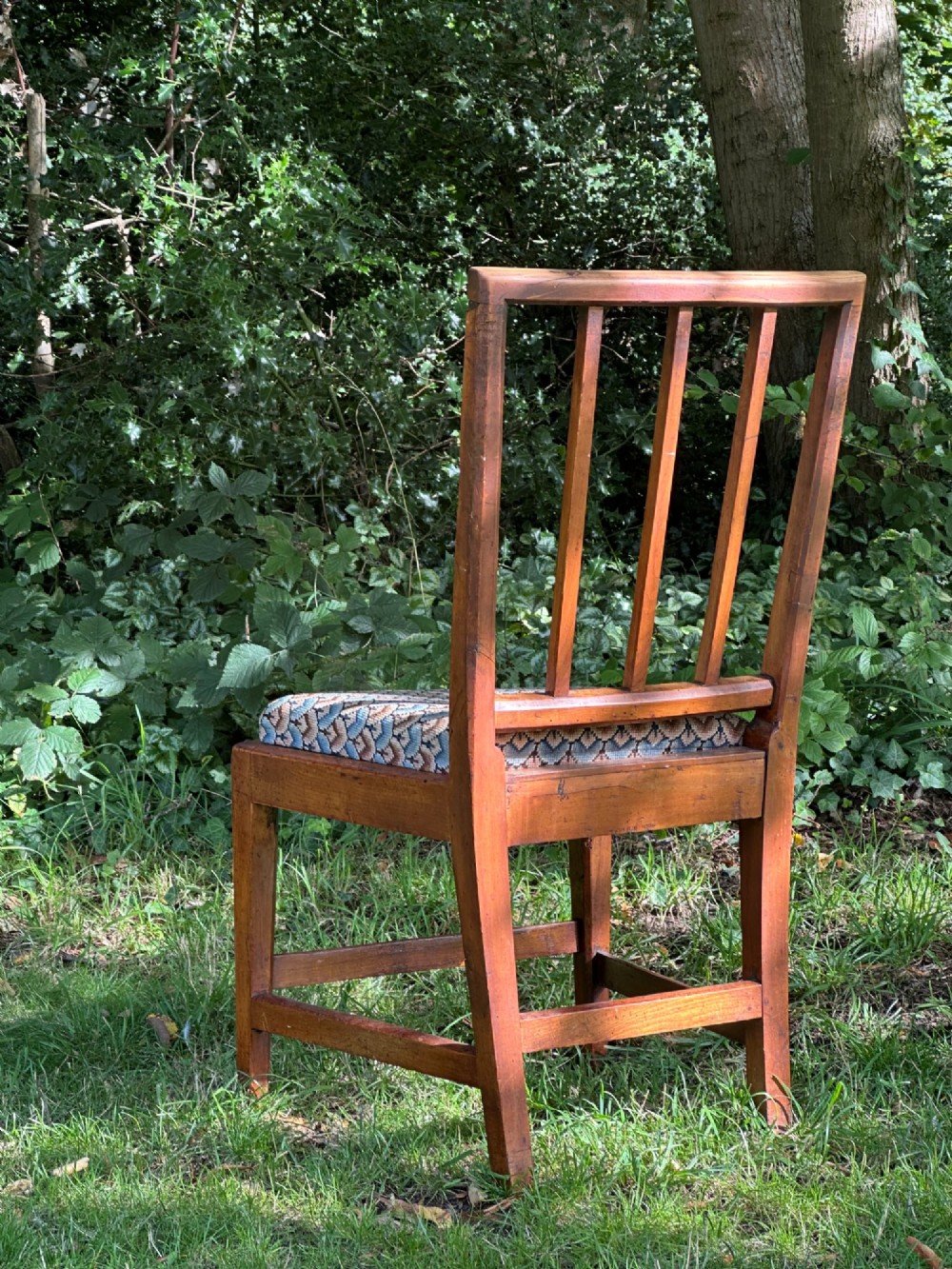 A George III solid birch side chair featuring a vertical reeded slat back, patterned geometric fabric seat, and square tapered legs with stretchers. View VI