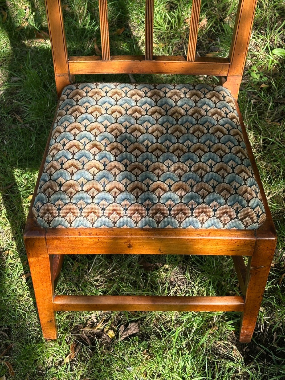 A George III solid birch side chair featuring a vertical reeded slat back, patterned geometric fabric seat, and square tapered legs with stretchers. View VII