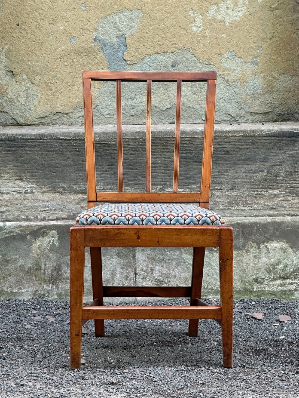 A George III solid birch side chair featuring a vertical reeded slat back, patterned geometric fabric seat, and square tapered legs with stretchers. View XI