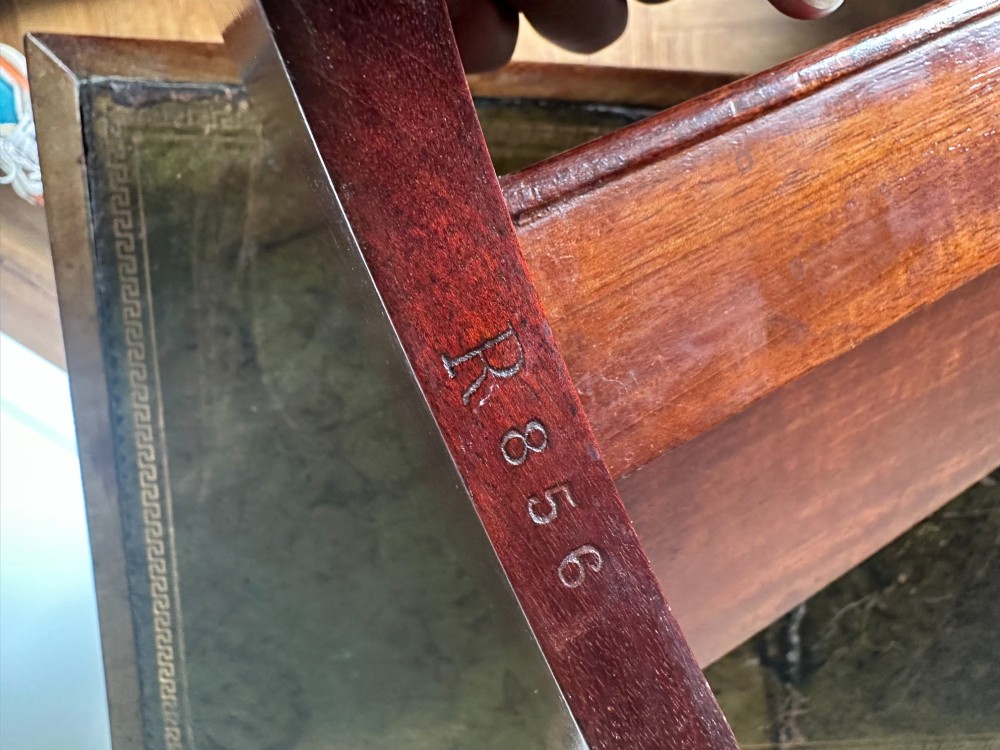 A late Victorian mahogany standing book trough featuring an upper angled trough, a small frieze drawer, turned pedestal stem, and tripod legs. View III