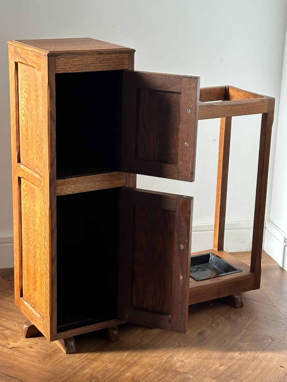 An English Arts and Crafts oak stick stand, in the manner of Heals View IV