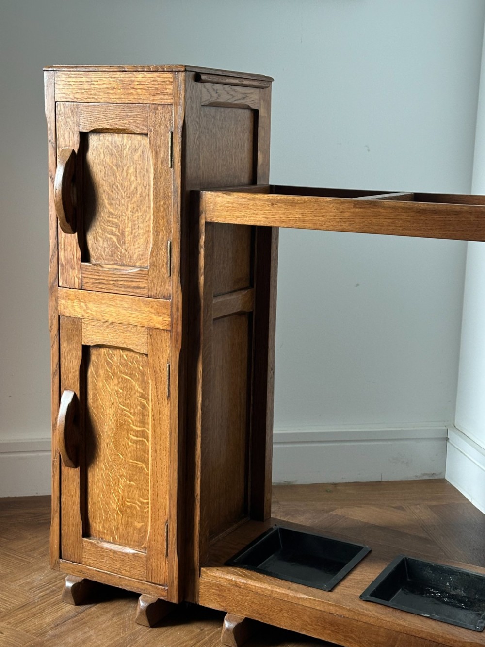 An English Arts and Crafts oak stick stand, in the manner of Heals View V