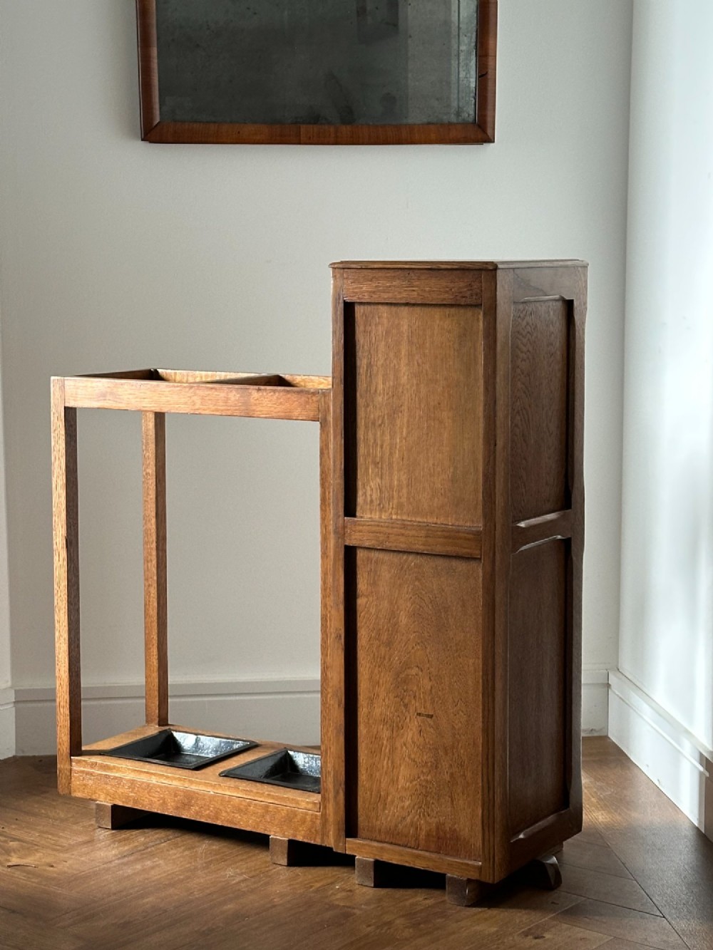 An English Arts and Crafts oak stick stand, in the manner of Heals View VI