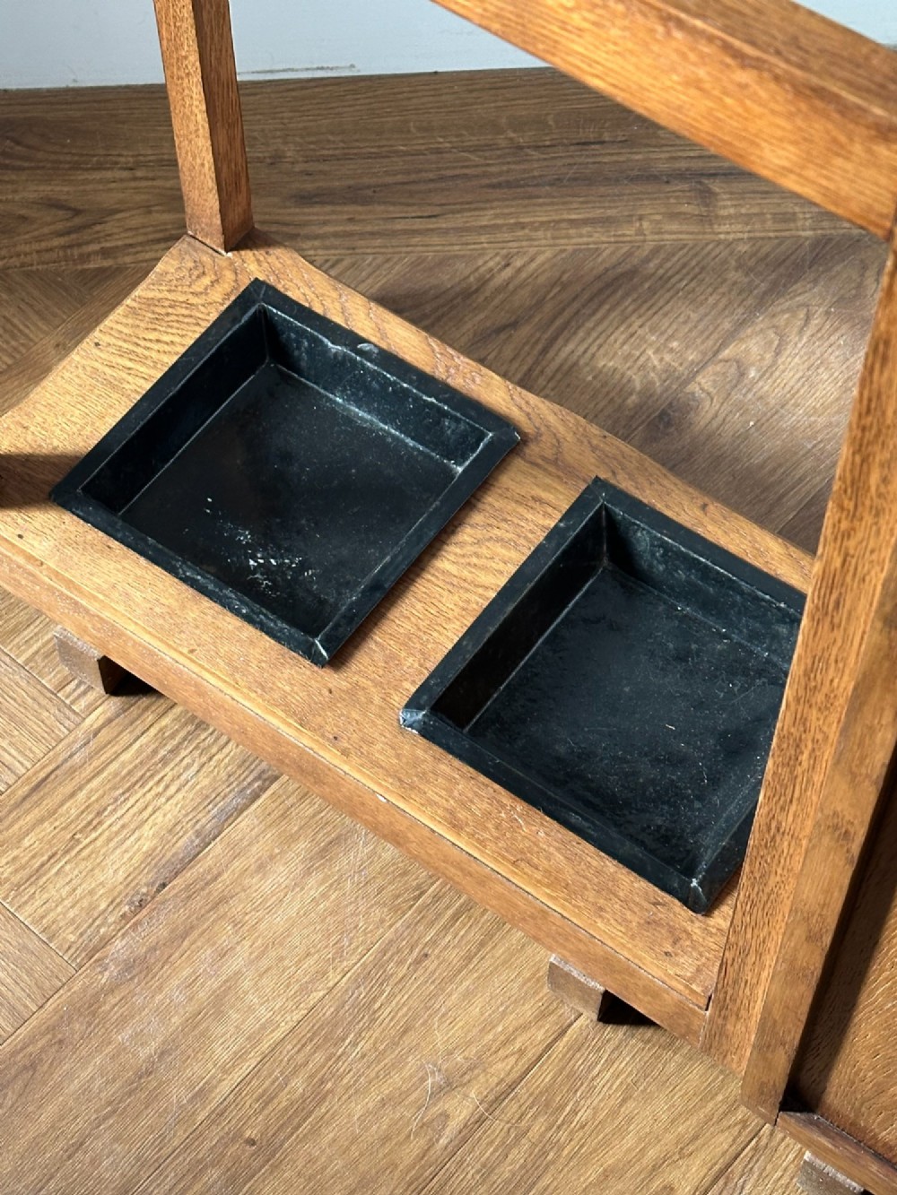 An English Arts and Crafts oak stick stand, in the manner of Heals View VII