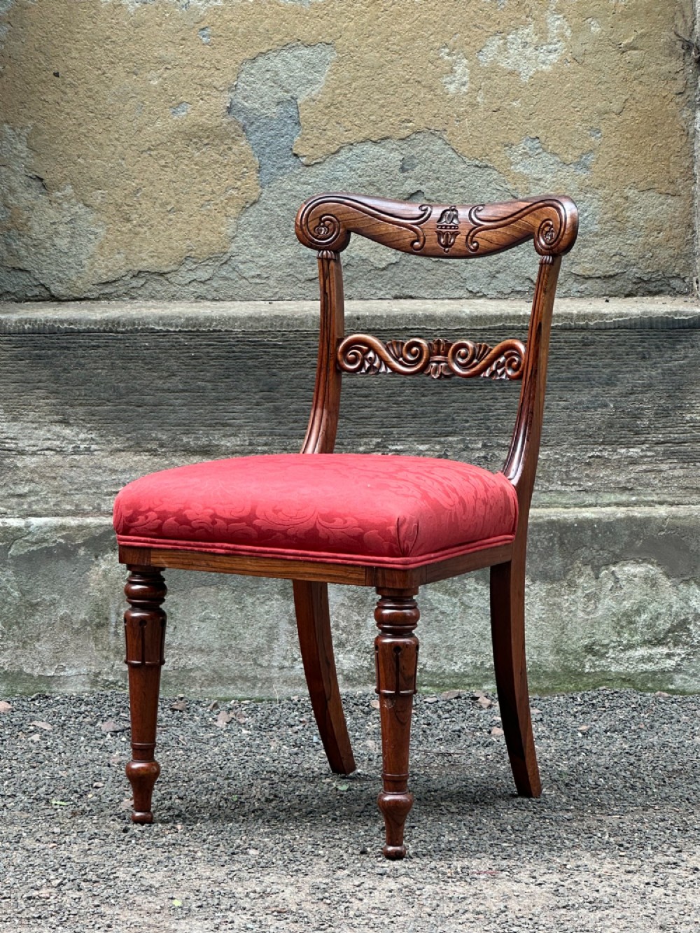 Set of six antique George IV rosewood dining chairs featuring carved top rails, horizontal back splats, turned front legs, and red upholstered seats. View VIII