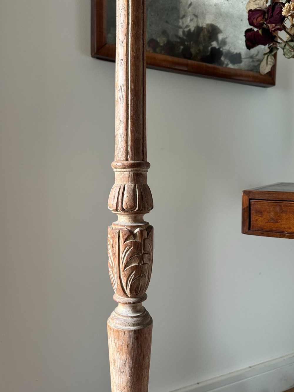 A carved limed oak floor lamp from the 1920s featuring a fluted column, leaf motifs, and a circular base. View III
