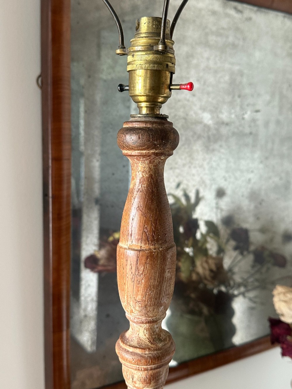 A carved limed oak floor lamp from the 1920s featuring a fluted column, leaf motifs, and a circular base. View IV