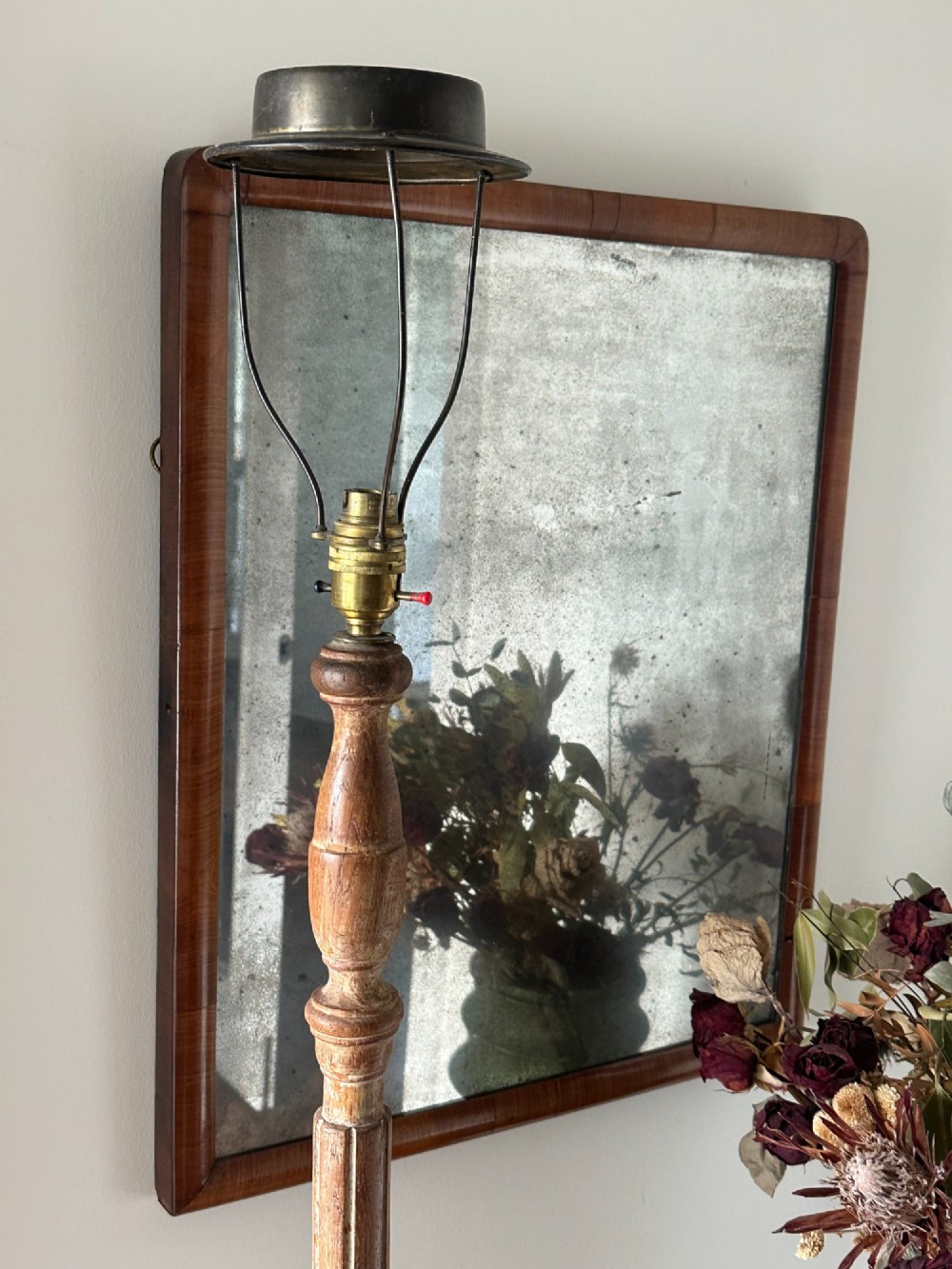 A carved limed oak floor lamp from the 1920s featuring a fluted column, leaf motifs, and a circular base. View V