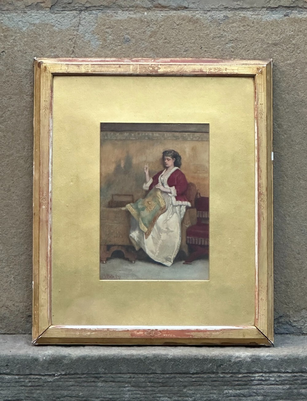 A 19th-century watercolour painting depicting a woman in a red jacket and white dress seated while engaged in needlework. View II