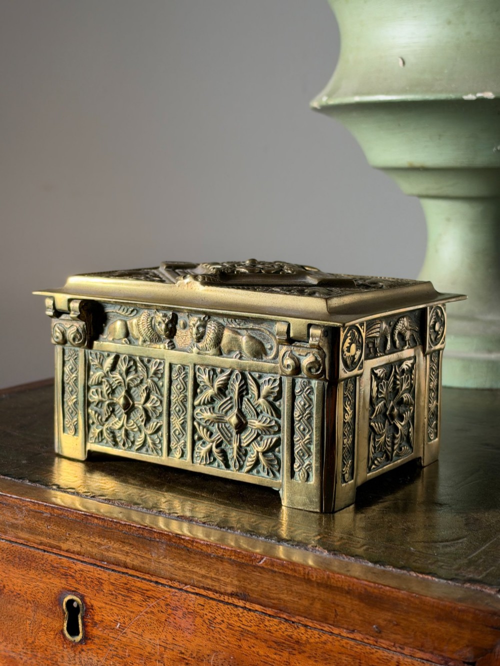 A nineteenth-century rectangular cast brass casket featuring detailed relief ornamentation of animals, foliage, and geometric patterns. View IV
