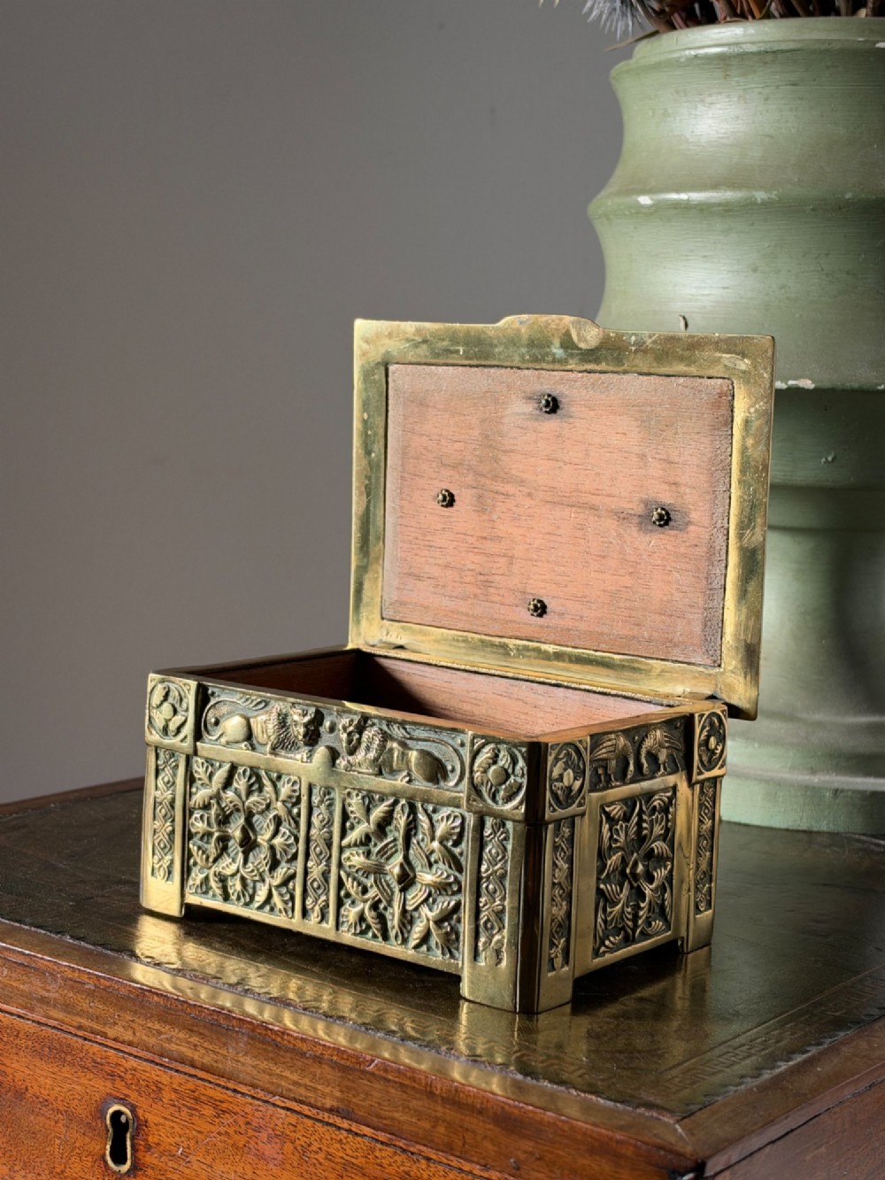 A nineteenth-century rectangular cast brass casket featuring detailed relief ornamentation of animals, foliage, and geometric patterns. View VII