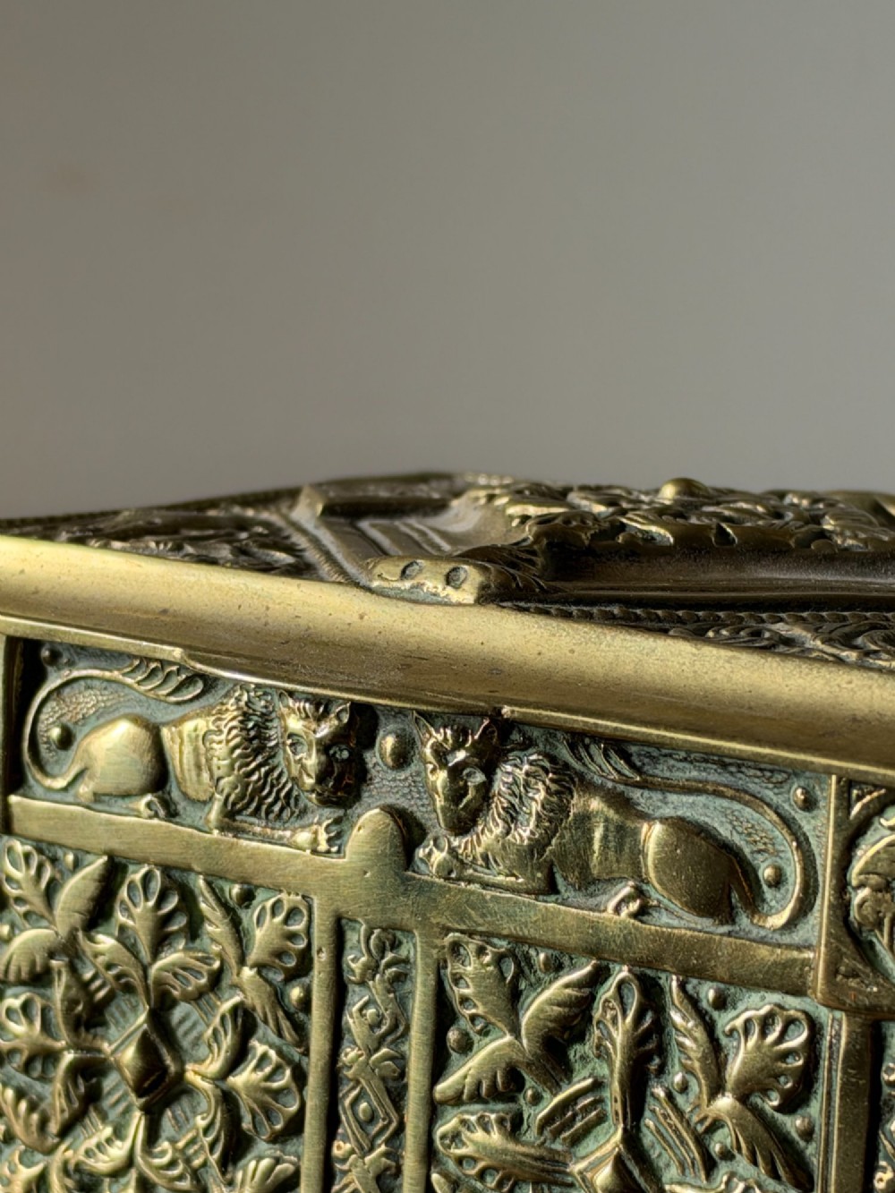A nineteenth-century rectangular cast brass casket featuring detailed relief ornamentation of animals, foliage, and geometric patterns. View IX