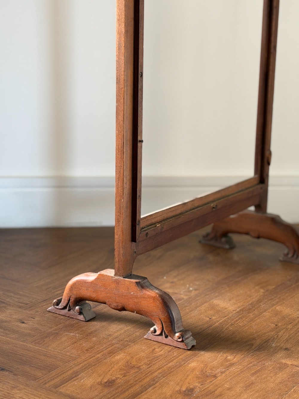 A freestanding Anglo-Indian carved walnut screen frame featuring an arched floral crest and splayed scrolled feet. View III