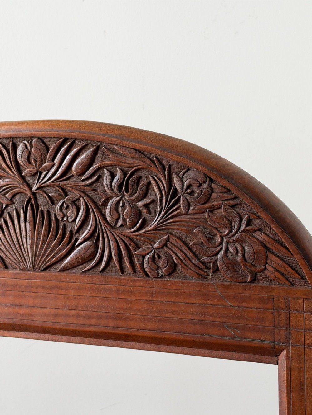 A freestanding Anglo-Indian carved walnut screen frame featuring an arched floral crest and splayed scrolled feet. View IV