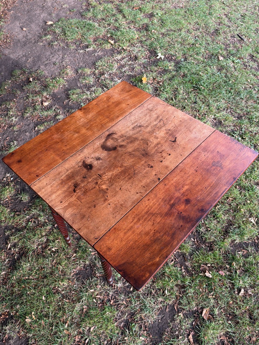 A George IV mahogany drop-leaf table featuring spiral turned legs, a single drawer with twin pull knobs, and two folding side leaves. View VII