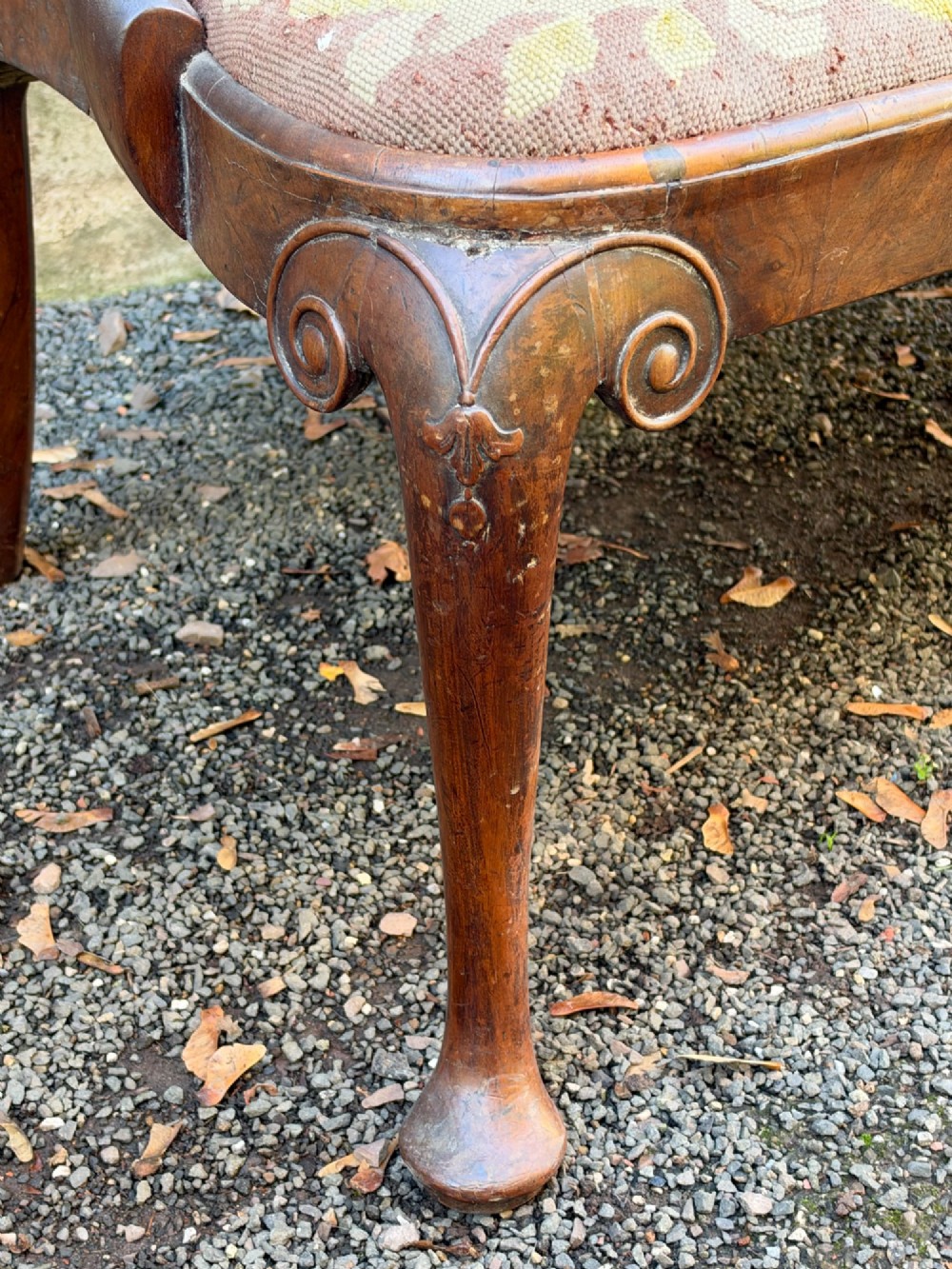 A late nineteenth-century George II style double chair-back settee in warm brown walnut and burr walnut with shepherd crook arms and an upholstered seat. View V