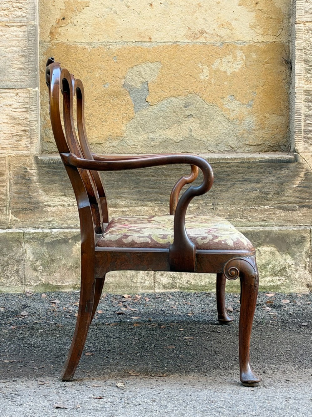 A late nineteenth-century George II style double chair-back settee in warm brown walnut and burr walnut with shepherd crook arms and an upholstered seat. View VI