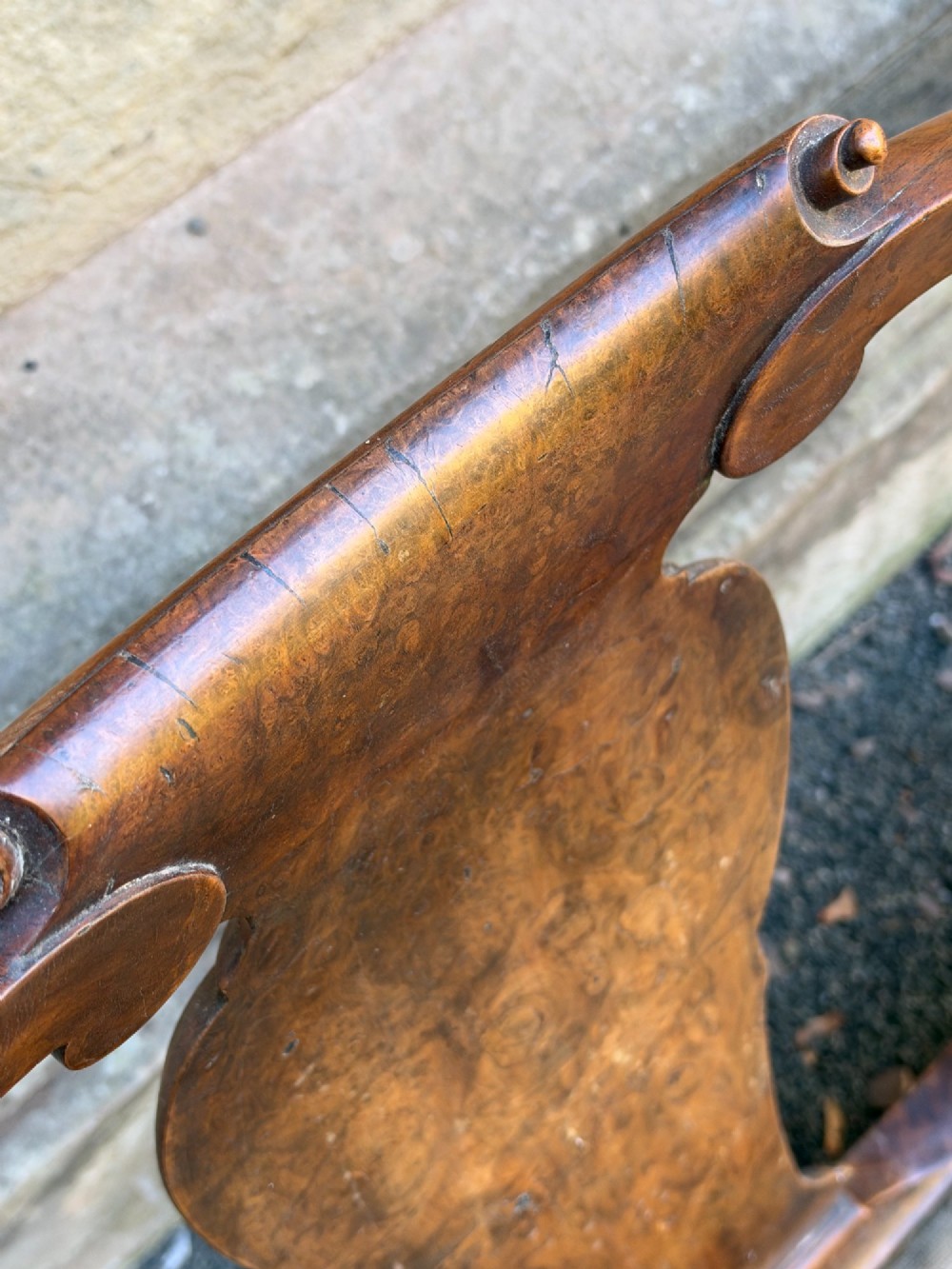 A late nineteenth-century George II style double chair-back settee in warm brown walnut and burr walnut with shepherd crook arms and an upholstered seat. View VII