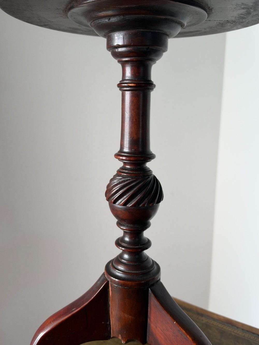 A late 19th-century George III style dark mahogany kettle stand with a circular dish top, spiral-carved baluster column, and tripod cabriole legs. View III