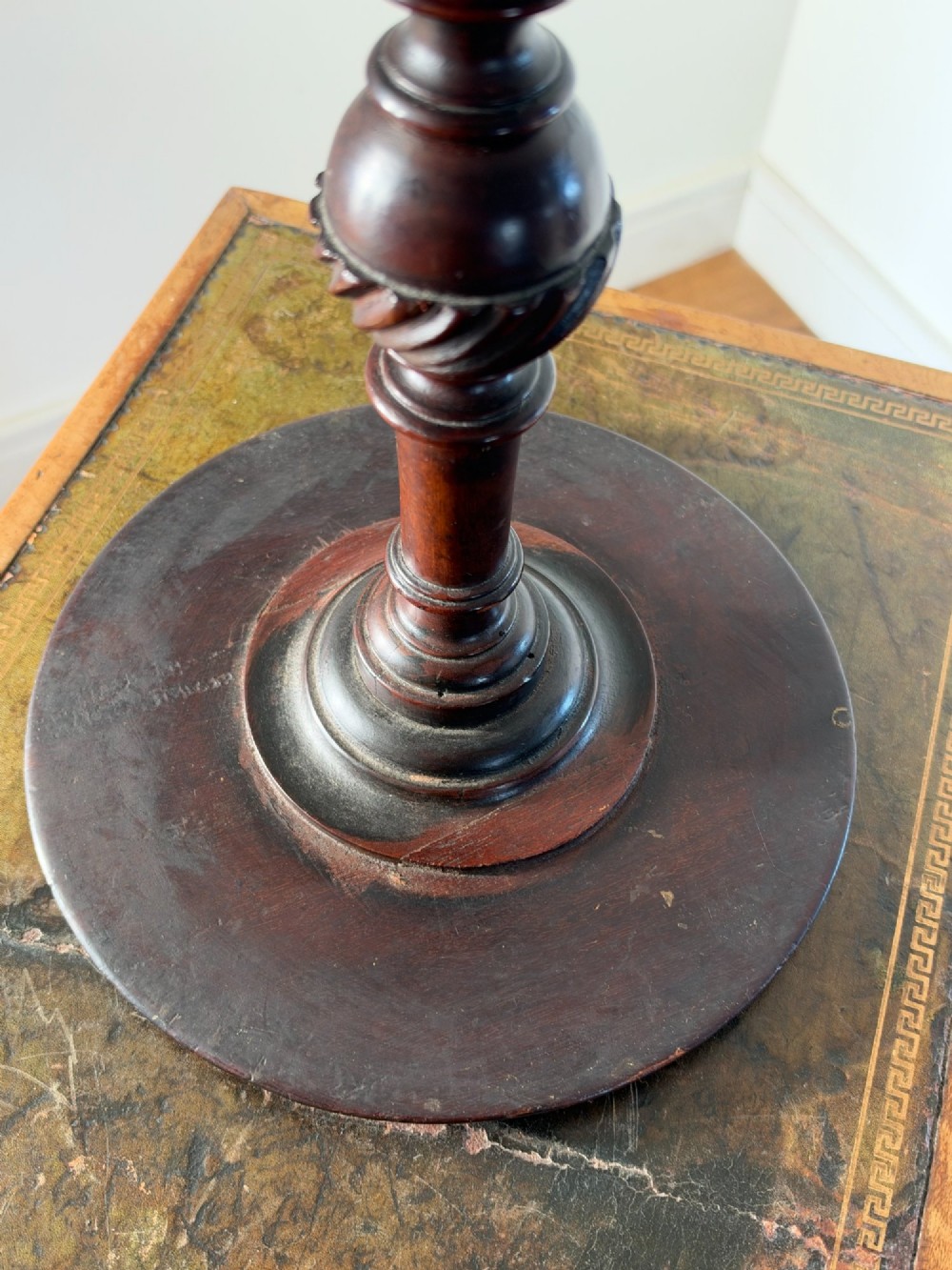 A late 19th-century George III style dark mahogany kettle stand with a circular dish top, spiral-carved baluster column, and tripod cabriole legs. View IX