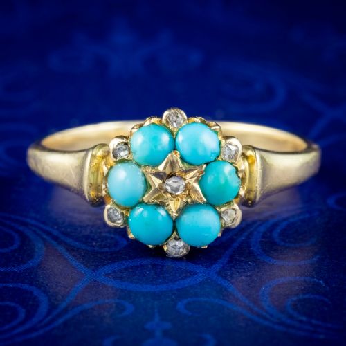 fig 1. A Victorian gold ring featuring a floral cluster of bright blue turquoise cabochons surrounding a star-set central diamond.