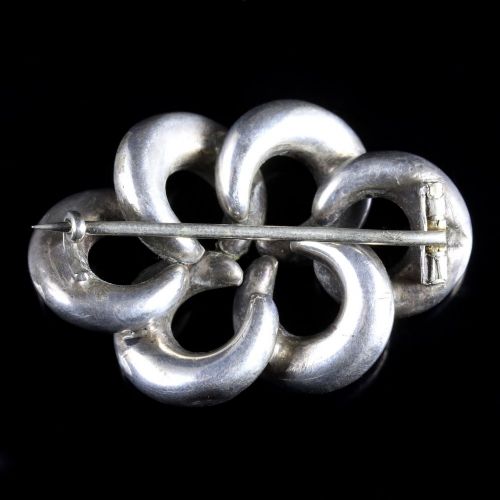 fig 1. An antique Victorian silver brooch formed of interlocked loops with hand-engraved details and inlaid with multi-coloured agates and jaspers.