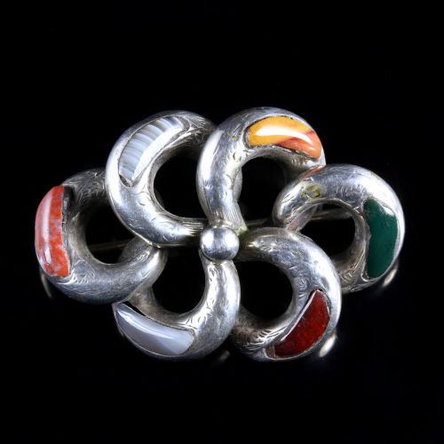 fig 2. An antique Victorian silver brooch formed of interlocked loops with hand-engraved details and inlaid with multi-coloured agates and jaspers.