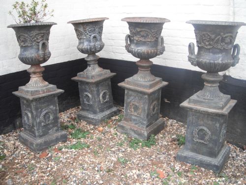 4 Matching Cast Iron Garden Urns on Stands