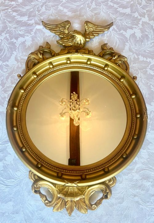 Regency Style Convex Carved and Gilded Mirror.
