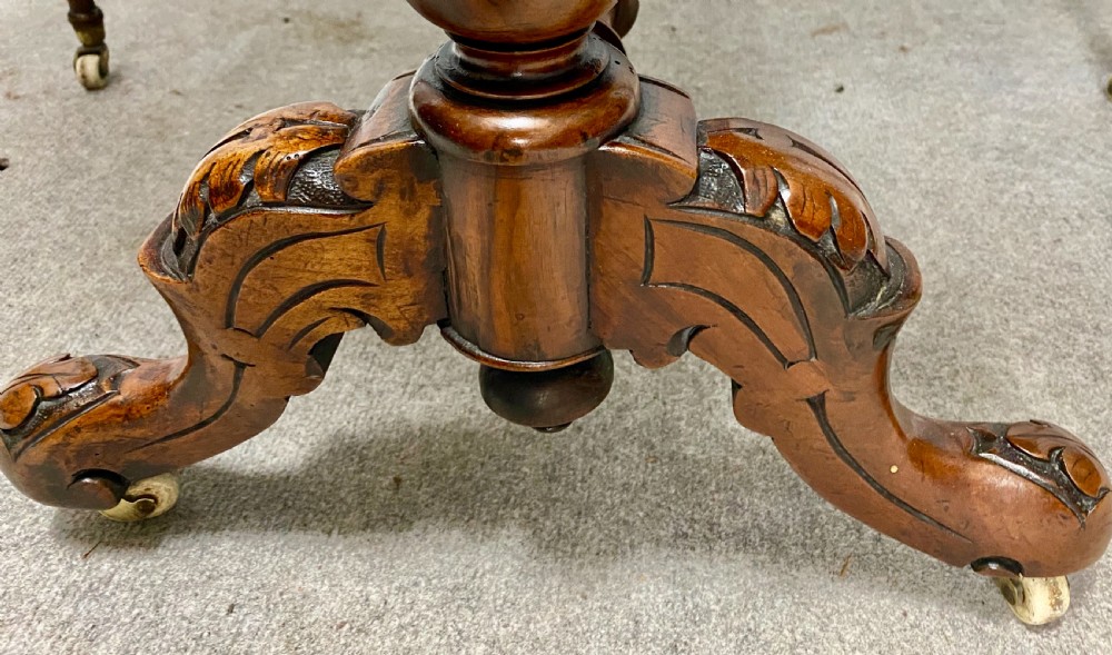 A Victorian burr walnut drop-leaf table featuring symmetrical figured grain, turned supports, spiral stretchers, and carved legs on castors. View VI