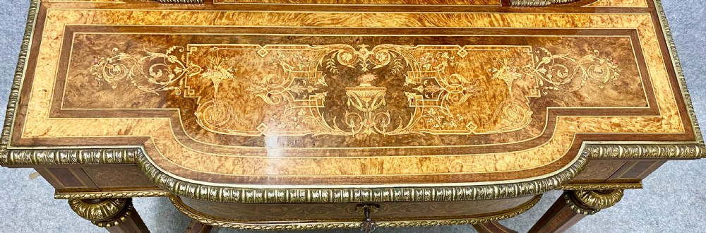 A Louis XVI Revival bonheur du jour writing desk with intricate floral marquetry inlay, a central cabinet door, gilt-bronze mounts, and fluted tapered legs. View II