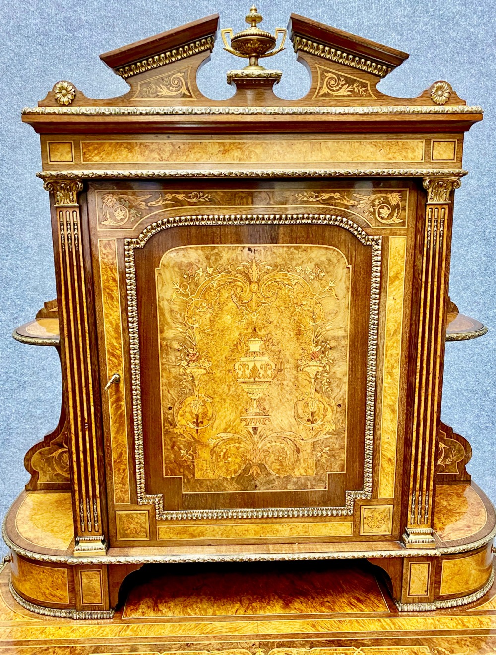 A Louis XVI Revival bonheur du jour writing desk with intricate floral marquetry inlay, a central cabinet door, gilt-bronze mounts, and fluted tapered legs. View III