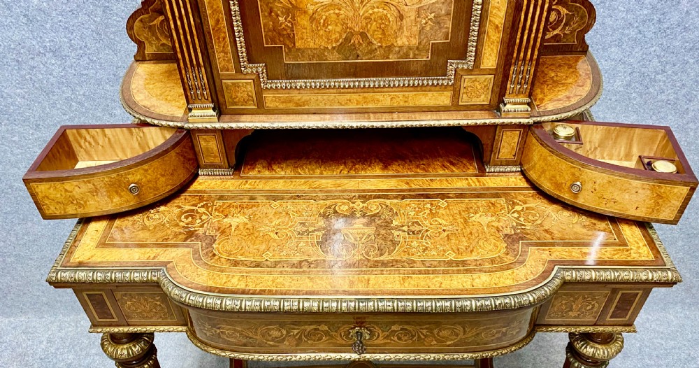 A Louis XVI Revival bonheur du jour writing desk with intricate floral marquetry inlay, a central cabinet door, gilt-bronze mounts, and fluted tapered legs. View IV