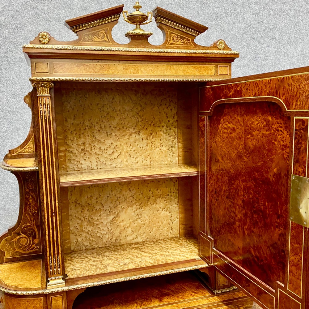 A Louis XVI Revival bonheur du jour writing desk with intricate floral marquetry inlay, a central cabinet door, gilt-bronze mounts, and fluted tapered legs. View VI