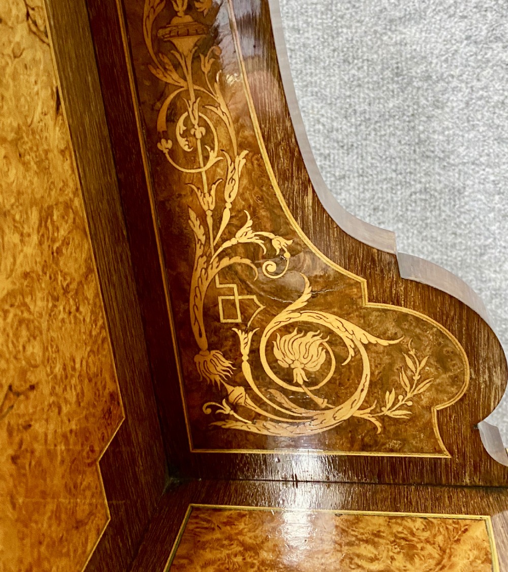 A Louis XVI Revival bonheur du jour writing desk with intricate floral marquetry inlay, a central cabinet door, gilt-bronze mounts, and fluted tapered legs. View IX
