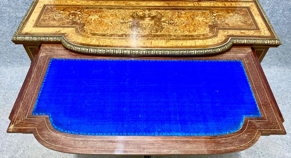 A Louis XVI Revival bonheur du jour writing desk with intricate floral marquetry inlay, a central cabinet door, gilt-bronze mounts, and fluted tapered legs. View XIII