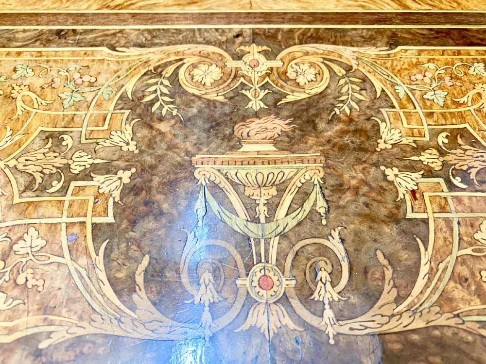 A Louis XVI Revival bonheur du jour writing desk with intricate floral marquetry inlay, a central cabinet door, gilt-bronze mounts, and fluted tapered legs. View XV