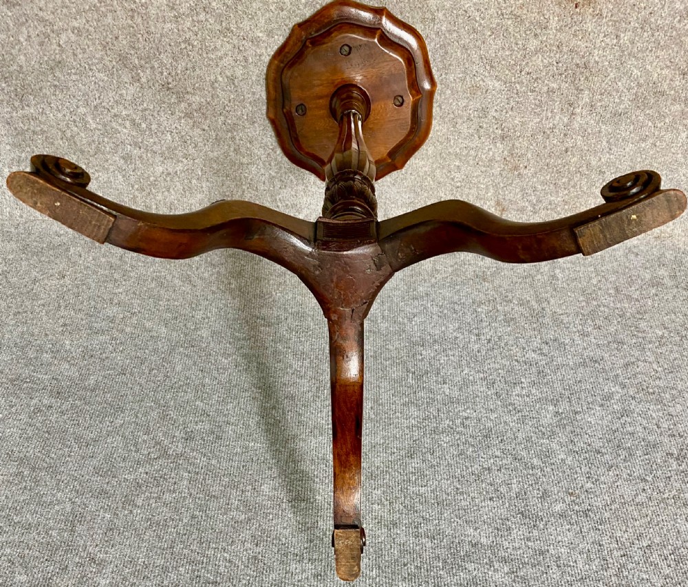 A wooden Hepplewhite style wine table featuring a scalloped top, a fluted central pedestal stem, and three carved tripod legs. View VI
