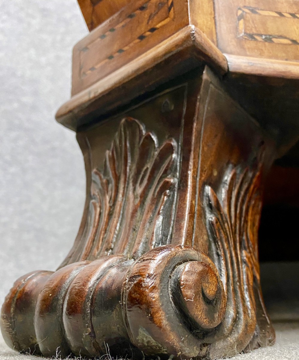 A Dutch marquetry cylinder bureau crafted from warm brown wood with trompe loeil writing tool inlays, fitted drawers, brass handles, and a curved bombe base. View XV