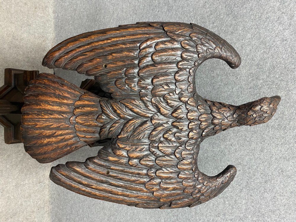 A dark carved oak eagle lectern featuring a sculpture of an eagle with wings spread mounted on an architectural pedestal stand. View VI
