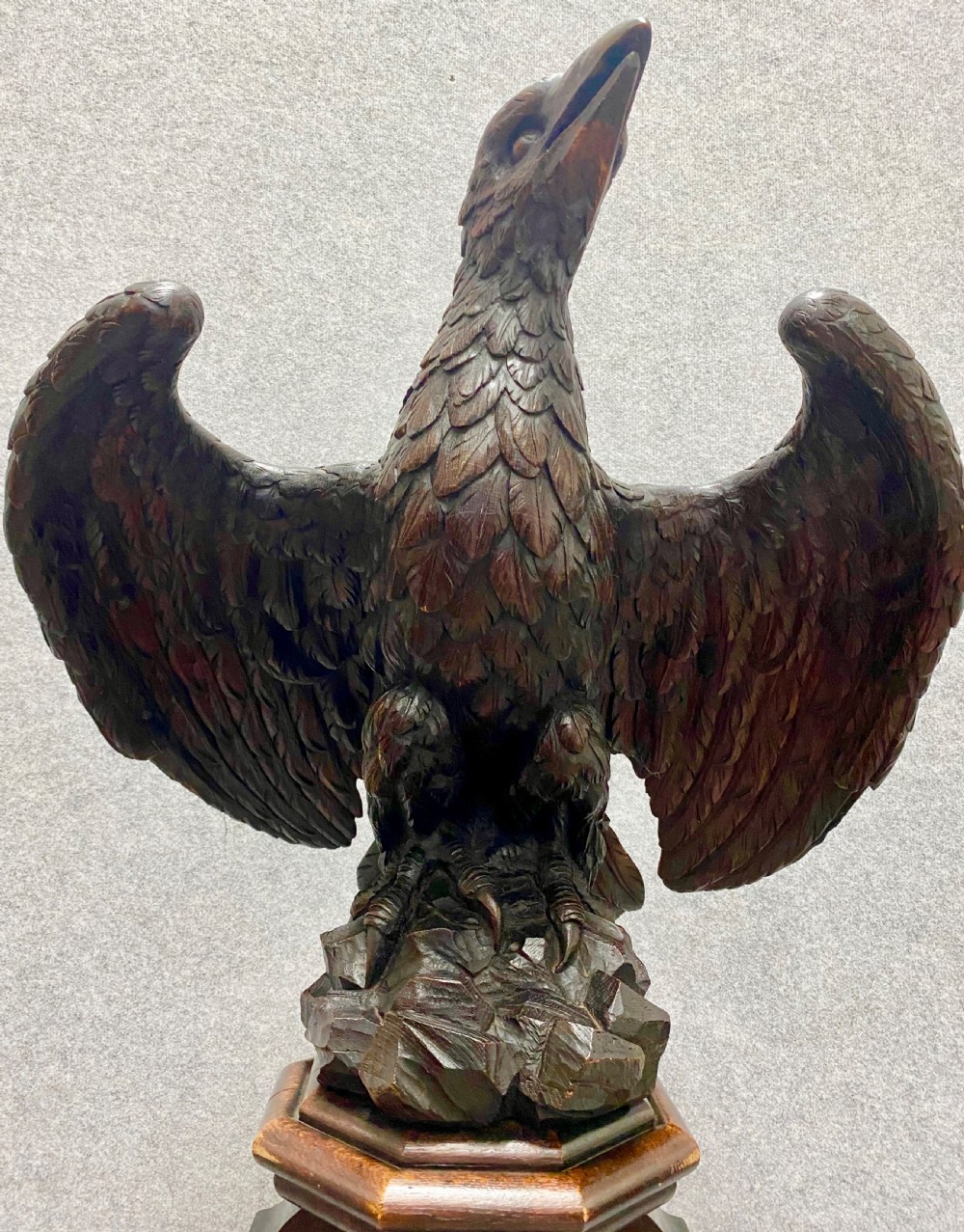 A dark carved oak eagle lectern featuring a sculpture of an eagle with wings spread mounted on an architectural pedestal stand. View X