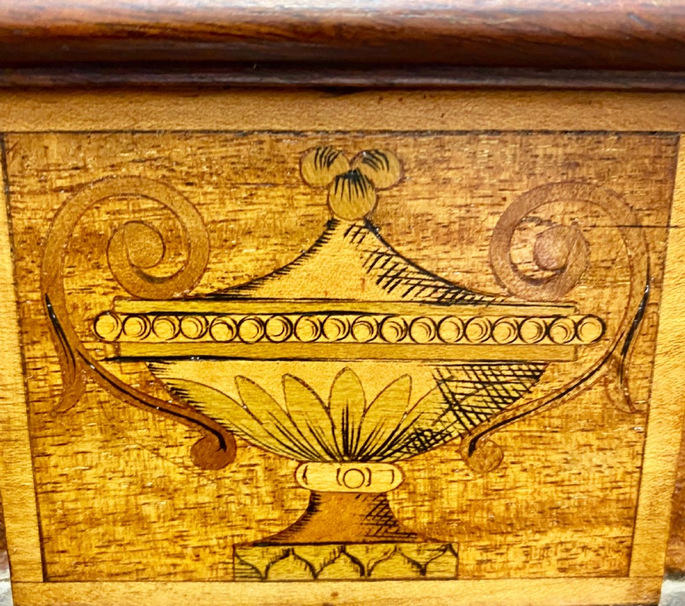 A tall mahogany and satinwood inlaid corner cabinet featuring a broken swan-neck pediment, upper astragal glazed double doors, and lower panelled cupboard doors. View II