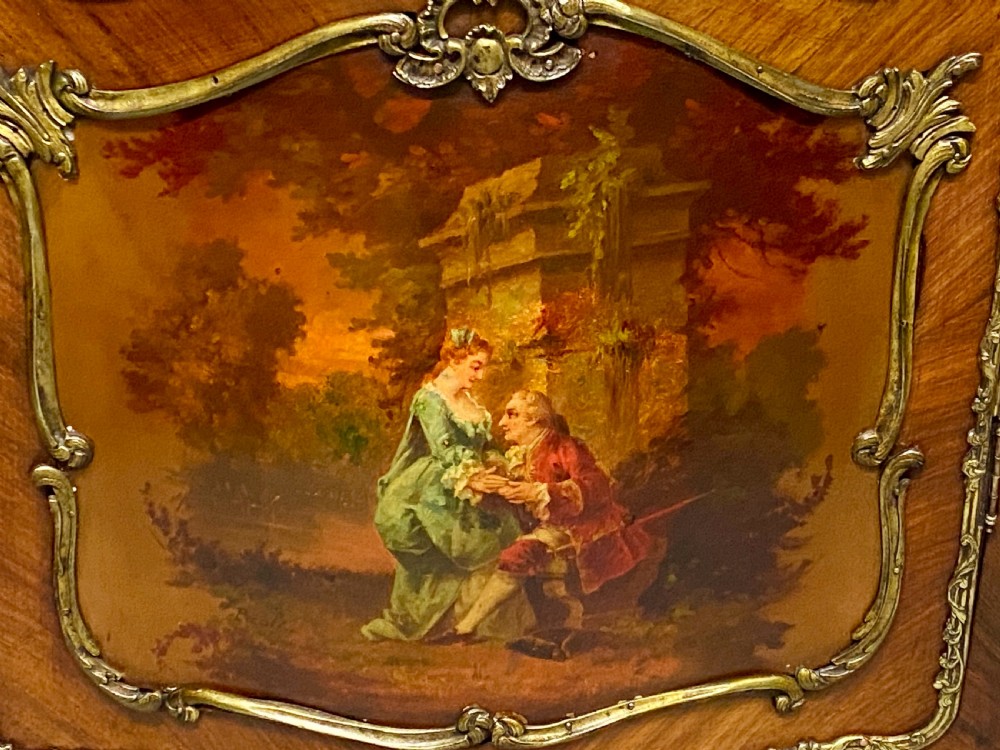 An antique French Louis XV style vitrine featuring serpentine glass sides, ornate gilt bronze mounts, and a lower painted Vernis Martin panel on cabriole legs. View IX