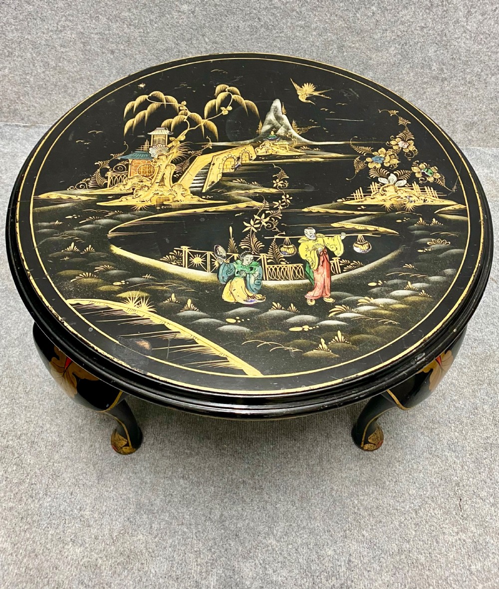 A round black lacquered coffee table with hand-painted gilded Chinoiserie landscape scenes and cabriole legs. View II